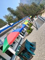 a row of chairs and umbrellas on a beach at Hotel HBH Himalaya's Beautiful Hills in Uttarkāshi