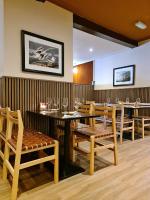 a dining room with wooden tables and chairs at The Alyth Hotel in Alyth