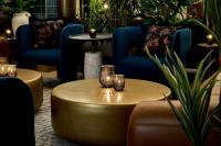 a living room with a gold coffee table and chairs at Viceroy Chicago in Chicago