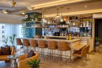 a bar in a restaurant with chairs and a bar counter at Viceroy Chicago in Chicago