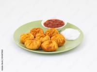 a plate of onion rings and a bowl of chili at Haritha Beach Resort Kothakoduru in Nellore