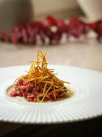 un piatto bianco ricoperto di cibo su un tavolo di Hotel-Restaurant Beim Schlass a Wiltz