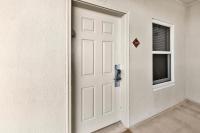 eine weiße Tür in einem Zimmer mit Fenster in der Unterkunft Ariel Dunes I Unit 1209 Gulf view in Destin