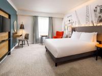 a hotel room with a bed and a desk at Mercure Cardiff North Hotel in Cardiff