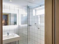 a bathroom with a shower and a sink at Mercure Cardiff North Hotel in Cardiff