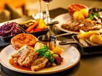 a table with three plates of food on it at Mercure Cardiff North Hotel in Cardiff