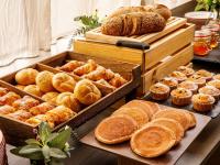 a bunch of different types of bread and pastries at Mercure Cardiff North Hotel in Cardiff