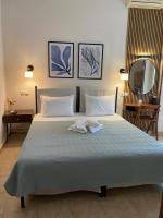 a bedroom with a large bed with two towels on it at ΑΡΓΩ in Kala Nera