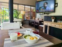 Una mesa de desayuno con un tazón de comida y un televisor. en 清迈三诺河畔精品度假酒店 Sannot Riverside Boutique Hotel, en Chiang Mai