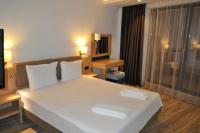 A bed or beds in a room at Hotel Tyulenovo