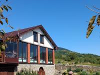 a house with glass walls and a roof at Kolochava Eco Resort in Kolochava