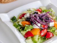 a salad with vegetables in a white bowl at Kolochava Eco Resort in Kolochava