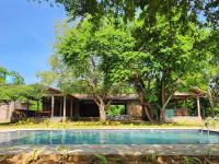 a swimming pool in front of a house at Hide Yala in Tissamaharama