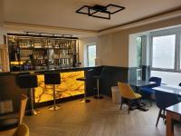a bar in a restaurant with tables and chairs at The Gatwick White House Hotel in Horley