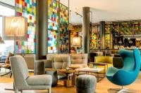 Un vestíbulo con sillas y un bar con azulejos de colores. en Motel One Köln-Neumarkt, en Colonia