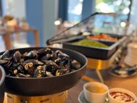 a table with two pans of food on a table at SeeSea Hotel in Vodice