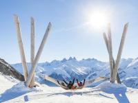 a group of people laying in a hammock in the snow at Apartment Soyouz Vanguard-96 by Interhome in Le Corbier
