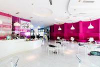 a restaurant with pink walls and white tables and chairs at S-a-f-e Haven Resort Staycation in Manila