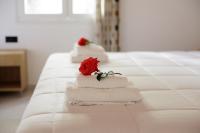 A bed or beds in a room at Santos Holidays