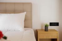 A bed or beds in a room at Santos Holidays