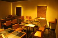 a dining room with tables and chairs and a window at Hotel Kek Grand Pvt Ltd in Chennai