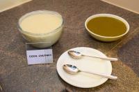 a counter with a plate and a bowl of soup and spoons at Hotel Kek Grand Pvt Ltd in Chennai