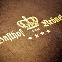 a close up of two gold crowns on a cushion at Hotel Gasthof Krönele in Lustenau