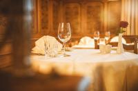 a table with two wine glasses and a flower on it at Hotel Gasthof Krönele in Lustenau