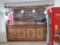 a coffee shop with a counter and a coke machine at Bujtina Gjerbes in Gjerbës
