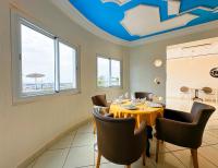 a dining room with a table and chairs at Hotel Ait Baamrane in Sidi Ifni
