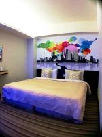 a bedroom with a large bed with a wall with umbrellas at Lio Hotel - Taipei Main Station in Taipei
