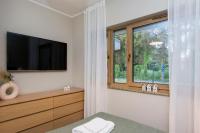 Televízia a/alebo spoločenská miestnosť v ubytovaní Bursztynowe Tarasy - Apartamenty