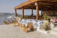 a pavilion with couches and chairs on a patio at Avantgarde Refined Yalıkavak in Yalıkavak