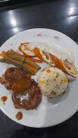 Un plato de comida con arroz, carne y verduras. en Guanahanì Sede campestre, en Pandi