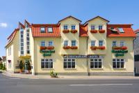 a large yellow building with flowers on the windows at DM Hotels & Apartments - Apartment Rasenweg in Dingelstädt