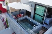 an overhead view of a swimming pool with an umbrella at Villas do Porto APTO 05 - Porto de Galinha in Porto De Galinhas