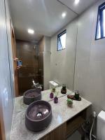 a bathroom with two sinks and a large mirror at Villas do Porto APTO 05 - Porto de Galinha in Porto De Galinhas