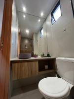 a bathroom with a toilet and a sink and a mirror at Villas do Porto APTO 05 - Porto de Galinha in Porto De Galinhas