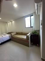a room with a couch and a bed and a window at Villas do Porto APTO 05 - Porto de Galinha in Porto De Galinhas