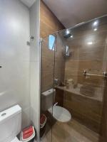 a bathroom with a toilet and a glass shower at Villas do Porto APTO 05 - Porto de Galinha in Porto De Galinhas