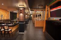 a restaurant with a row of tables and chairs at Dreams Flora Resort & Spa - All Inclusive in Punta Cana