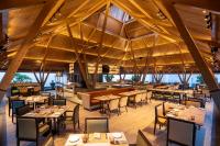 een afbeelding van een restaurant met tafels en stoelen bij Radisson Resort Hatgad Saputara in Saputara