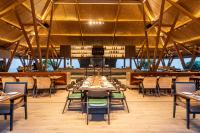 een grote eetkamer met tafels en stoelen bij Radisson Resort Hatgad Saputara in Saputara