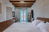 A bed or beds in a room at Villa Zanetti Mykonos