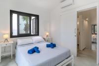 Postel nebo postele na pokoji v ubytování Meneou Blu Beach House*