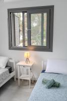 Postel nebo postele na pokoji v ubytování Meneou Blu Beach House*