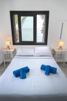 Postel nebo postele na pokoji v ubytování Meneou Blu Beach House*
