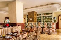 a restaurant with tables and chairs and a bar at Casa Monti Roma in Rome