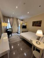 a bedroom with a large bed and a living room at St Martin Apartment in Vienna