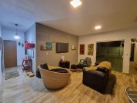 a living room with a couch and a tv at Pousada QUERÊNCIA FRANCÊS in Marechal Deodoro